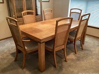 Overview of rectangular dining table with six matching chairs in room