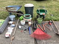 Full view of all gardening items including wheelbarrow, spreader, pots, tools, trash can