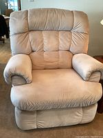 Front view of a large recliner chair with plush cushioning and creme linen fabric upholstery.