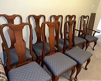 Group of all eight chairs in a row against wall