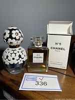 Both fragrance bottles shown side by side with Chanel No. 5 box visible