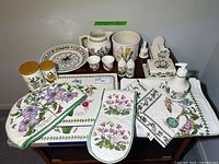 Overall grouping of porcelain items and linens on table