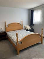 Angled view of full bed frame assembled on carpeted floor