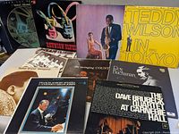 Photo showing 10 jazz and blues vinyl albums laid out on a flat surface, including Dave Brubeck Quartet, Roy Buchanan, Teddy Wilson, Dollar Brand and others.