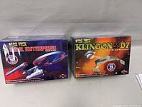 Front view of both model kit boxes showing Star Trek U.S.S. Enterprise and Klingon D7 Battlecruiser, sealed in original packaging.