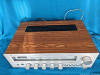 Full front and top view of Sherwood S-7250 receiver showing wood grain finish and silver faceplate with tuning dial and control knobs.