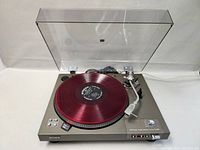 Front view with red demonstration record on platter and raised clear dust cover