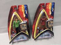 Packaged Star Trek action figures of Captain Kirk and Lieutenant Uhura.