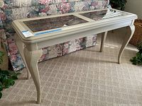 Front angle view of the light wood sofa table showing the etched glass inlay and cabriole legs.
