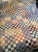 Full view of the quilt laid out showing overall patchwork design and colors.