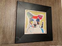 Frontal view of the framed dog collage art, showing the composition and coloring.
