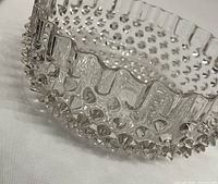 Close-up image showing the hobnail texture and wavy edge of the glass bowl.