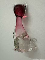 Front view of handblown glass cat with clear body and red shaded head and neck.