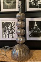 Full view of the mercury glass lamp showing the stacked orb design and dome base in a room setting.