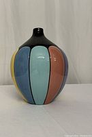 Front angled view showing vase shape and colorful vertical panels