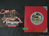 Photo showing the covers of two books on dragons, one by Scholastic and the other Dragonology.