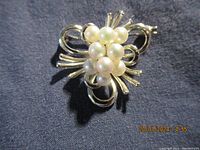 Front view of the vintage Bond Boyd sterling silver brooch with faux pearl floral cluster.
