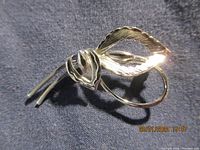 Front view of Bond Boyd sterling silver brooch pin showing floral design and leaf details.