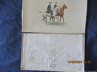 Handkerchiefs neatly folded inside box with lace and embroidered detailing