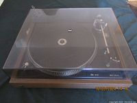 Full view of the Dual 506 turntable with dust cover on, showing overall condition and branding.