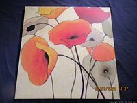 Photo showing large square floral artwork painting with warm colored stylized flowers on light background.