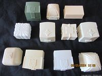 Top-down view of all 11 ring boxes closed, showcasing different shapes, colors, and decorative lid designs.