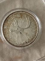Reverse of 1968 Canadian quarter showing a caribou, denomination, and year.