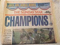 Front page of the Sunday Star newspaper with large headline 'CHAMPIONS', featuring a photo of Blue Jays players celebrating.