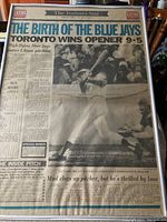 Full framed newspaper showing headline and main photo of Blue Jays player swinging a bat.