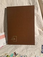 Brown leather-textured Philatex stamp stock book cover with gold foil logo
