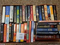 Photo of a book lot containing 26 various fiction and non-fiction books in paperback and hardcover formats.