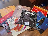 Several vinyl record albums laid out showing a variety of artists and genres including Alabama, Clint Atkins, Mozart, and Walt Disney soundtrack.