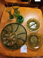Full view of lot showing three green glass vases, large divided appetizer platter with deviled egg section, and two green glass divided pickle dishes.