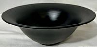 Wide flared black satin glass bowl with smooth matte finish, showing overall shape and texture.