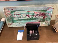 Full view of the colorful handmade ceramic tray on display, showing the abstract pattern and textured surface.