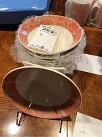 Photo showing stacked bowls with coral and white Sienna pattern, price tag visible