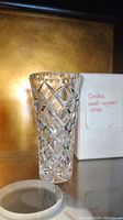 Small Ceska crystal vase with detailed cut crystal pattern shown from front with original box in background.