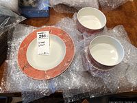 Photo showing bowls wrapped in protective bubble wrap with a label indicating 6 fruit and 6 soup bowls in the lot.