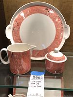 Photo showing all three items: cake plate, milk pitcher, and sugar bowl lined up together.