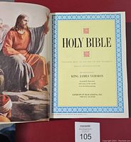 Title page displaying Holy Bible King James Version title with decorative blue border and artwork.