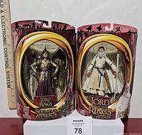 Front view of the two Lord of the Rings action figure packages showing Gandalf the White and the Elven Warrior figures with ruler for size reference.