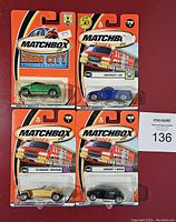 Front view of four sealed Matchbox cars in blister packagings on branded cards.