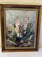 Full view of framed impressionist floral oil painting showing pink and white flowers with green leaves, signed by artist J Hill.