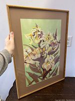 Framed watercolour painting showing iris flowers and overall condition.