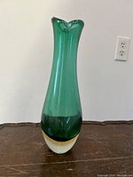 Front view of the emerald green Sommerso art glass vase showing smooth, tapered shape and color transition to clear and white base.