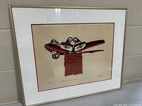 Front view of framed Randy Stiglitz limited edition print, showing Native mask with red, black and white colors and fringe detail.