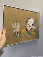 Framed vintage hand painted Chinese artwork showing child playing flute beside flower on textured paper.