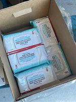 Box with 13 packages of Cardinal Health baby wipes visible, sealed in individual packs.