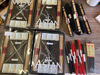 Photo showing packaged Asian Dinner Collection utensils including sushi mats, sauce dishes, and stainless steel chopsticks as well as loose chopsticks in black, bamboo, and red colors.