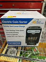 Box of Royal Sovereign Electric Coin Sorter showing features including patented anti-jam technology, 200 coin capacity, and ease of use.